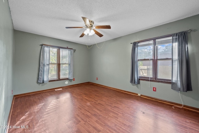 spare room with wood-type flooring, a textured ceiling, and ceiling fan