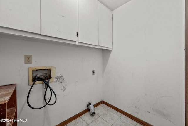 washroom featuring cabinets, hookup for a washing machine, hookup for an electric dryer, and a textured ceiling