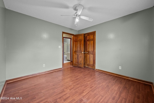 unfurnished room with wood-type flooring, ceiling fan, and a textured ceiling