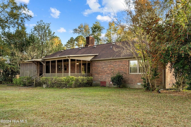 rear view of house with a yard