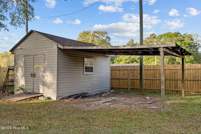 exterior space featuring a yard and a storage shed