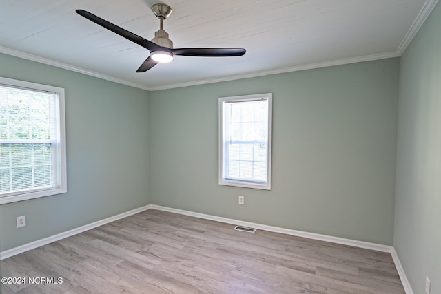 spare room with ornamental molding, ceiling fan, plenty of natural light, and light wood-type flooring