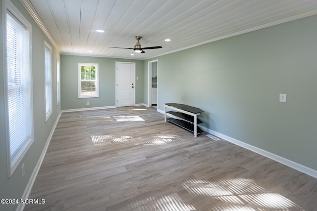 empty room featuring light hardwood / wood-style floors, wooden ceiling, ornamental molding, and ceiling fan