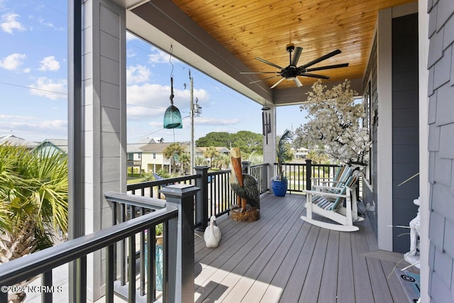 wooden deck featuring ceiling fan