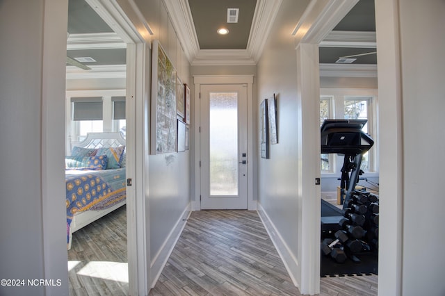 entryway featuring ornamental molding and hardwood / wood-style floors