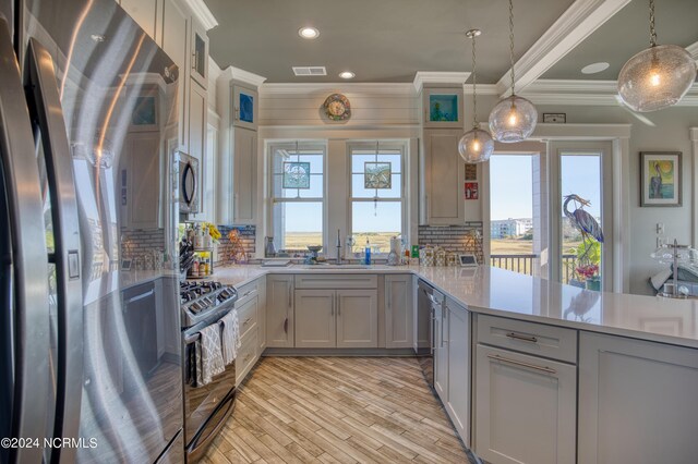 kitchen featuring gray cabinets, a healthy amount of sunlight, and sink