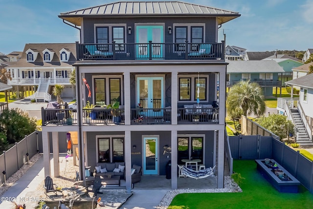 back of property featuring a patio and a balcony