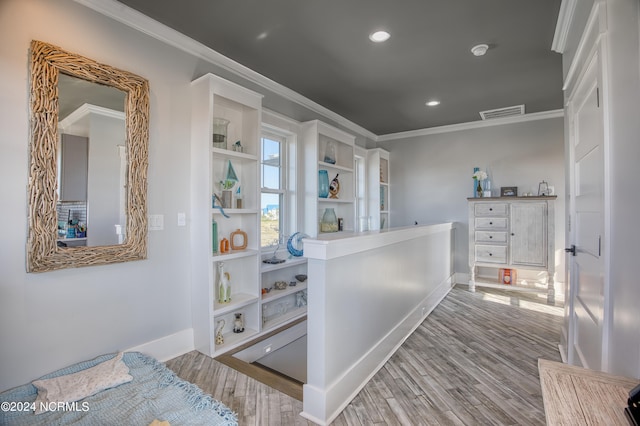 interior space featuring hardwood / wood-style flooring and crown molding