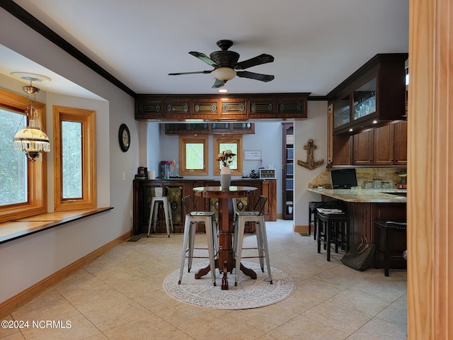 dining room with crown molding and ceiling fan