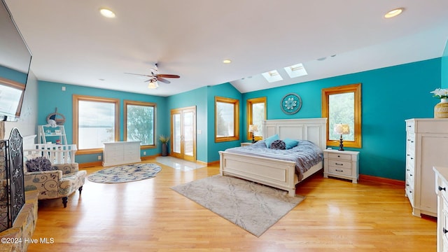 bedroom with lofted ceiling, multiple windows, light hardwood / wood-style floors, and ceiling fan