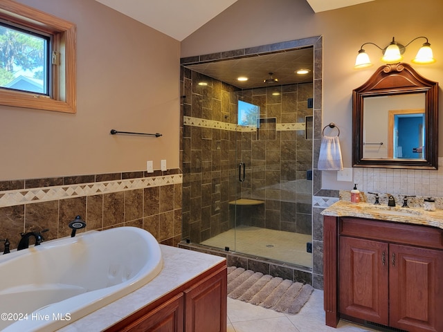 bathroom featuring lofted ceiling, tile walls, vanity, independent shower and bath, and tile patterned flooring