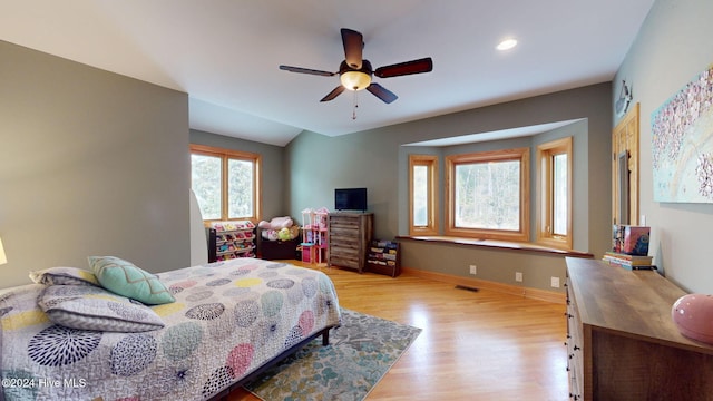 bedroom featuring lofted ceiling, light wood-type flooring, and ceiling fan