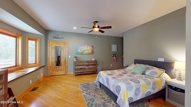 bedroom with ceiling fan and light hardwood / wood-style floors