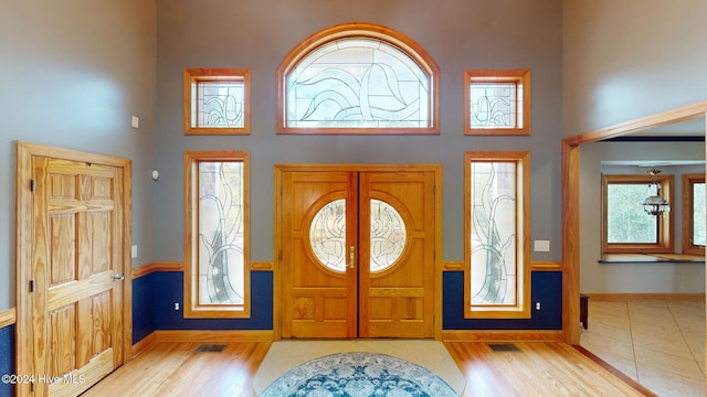 foyer featuring a high ceiling and light wood-type flooring