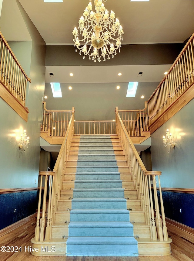 stairs featuring a skylight and wood-type flooring