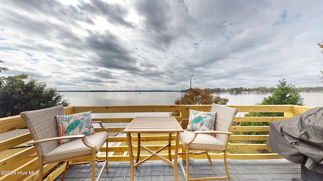 balcony featuring a water view and area for grilling