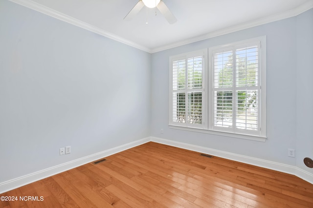 empty room featuring crown molding, wood-type flooring, and ceiling fan