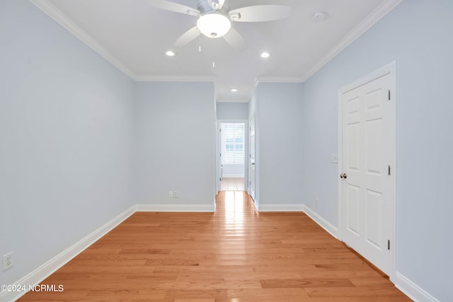 empty room featuring light hardwood / wood-style floors, ornamental molding, and ceiling fan