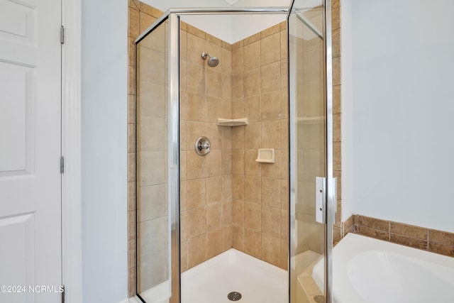 bathroom featuring separate shower and tub