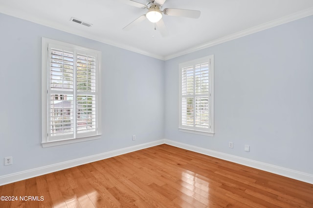 spare room with crown molding, light hardwood / wood-style flooring, and ceiling fan