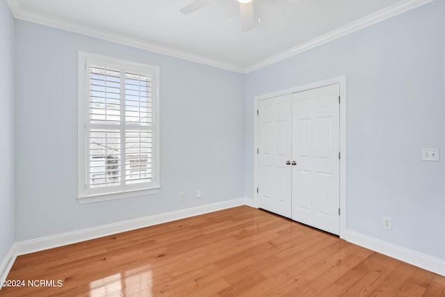 unfurnished bedroom with a closet, ceiling fan, ornamental molding, and light wood-type flooring