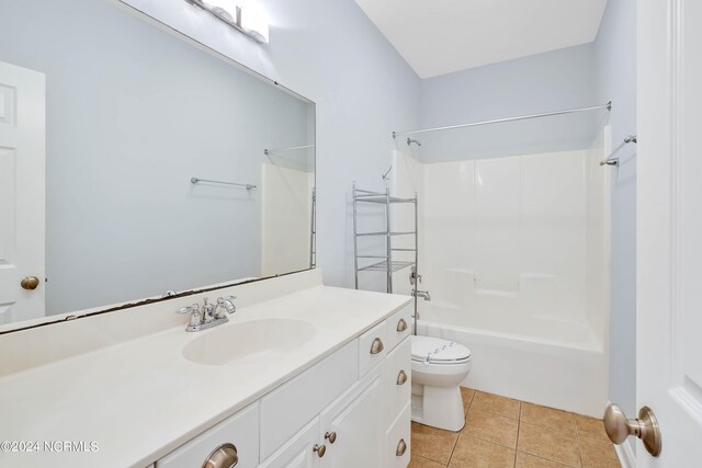 full bathroom with toilet, vanity, tile patterned floors, and tub / shower combination