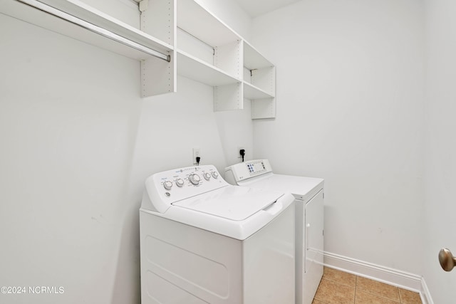 laundry room with light tile patterned flooring and separate washer and dryer