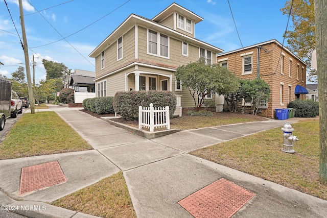 view of front of property with a front lawn and a garage