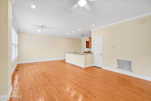 unfurnished living room featuring ornamental molding, light hardwood / wood-style flooring, and ceiling fan