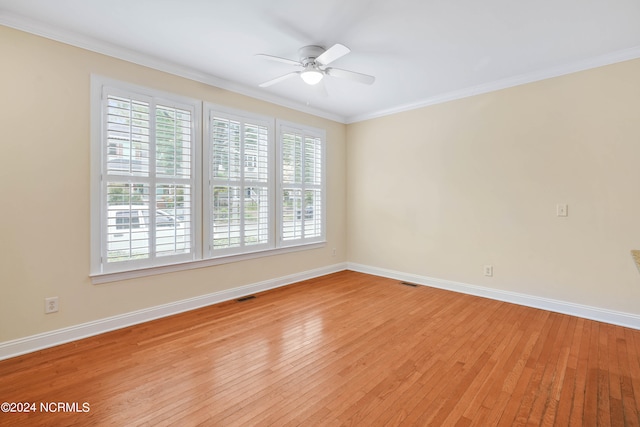 spare room featuring ornamental molding, plenty of natural light, and light wood-type flooring