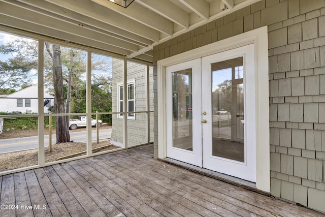 unfurnished sunroom featuring french doors