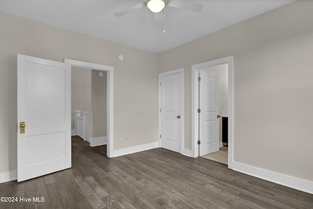 unfurnished bedroom with ceiling fan and dark hardwood / wood-style flooring