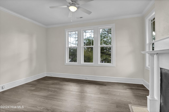 unfurnished living room featuring ceiling fan, dark hardwood / wood-style floors, and ornamental molding