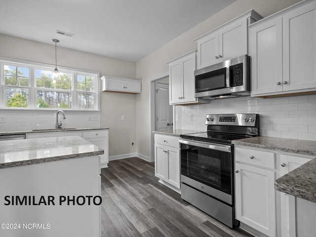 kitchen featuring appliances with stainless steel finishes, sink, hardwood / wood-style floors, and white cabinets