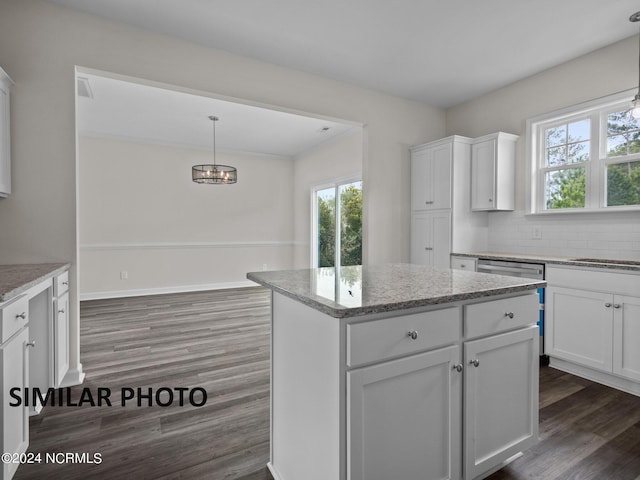 kitchen with white cabinets, a center island, dark wood-type flooring, and pendant lighting