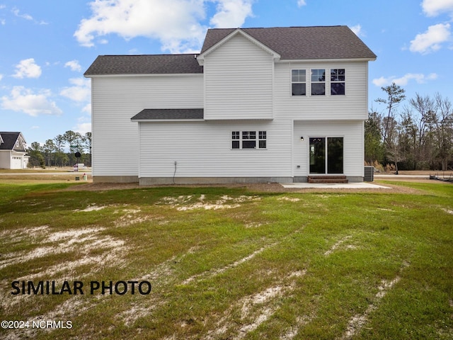 rear view of property with a patio and a lawn