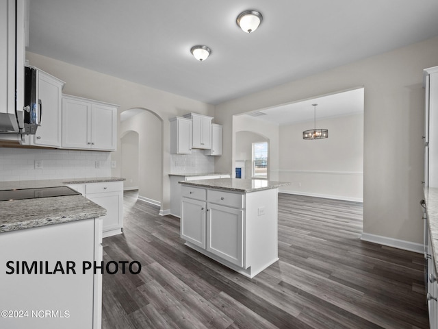 kitchen with white cabinets, dark hardwood / wood-style floors, and a kitchen island