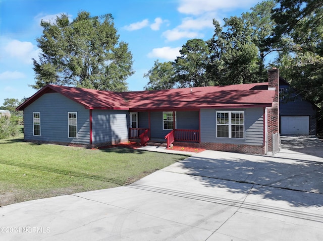 single story home with an outdoor structure, a garage, a front lawn, and a porch