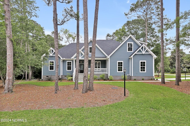 craftsman inspired home with a front lawn and covered porch