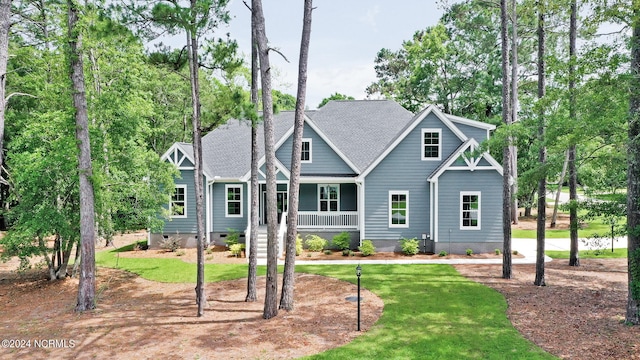 craftsman-style house with a front lawn and covered porch