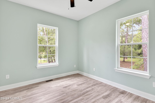 empty room featuring light hardwood / wood-style flooring and ceiling fan