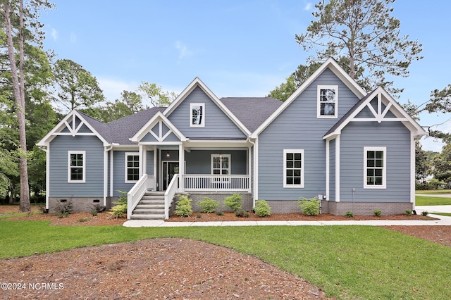 craftsman house with a front yard and a porch