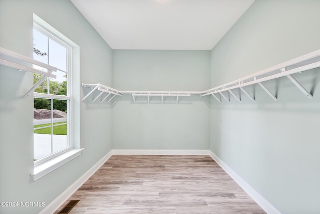 walk in closet featuring light hardwood / wood-style floors