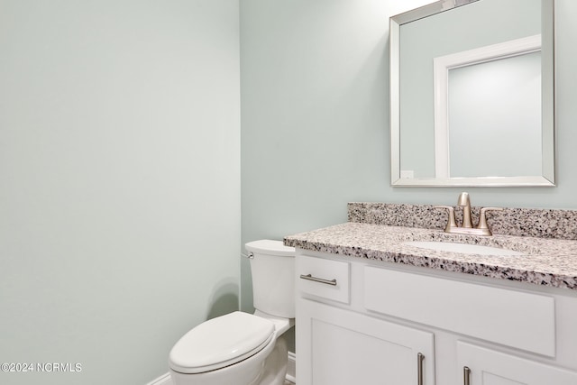 bathroom with toilet and vanity