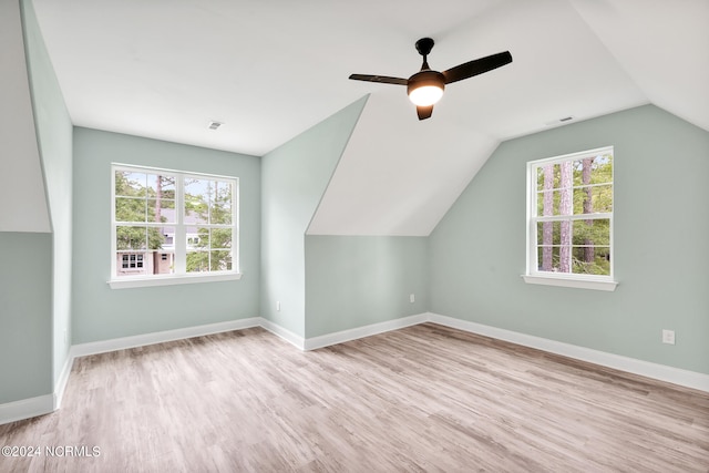 bonus room with light hardwood / wood-style flooring, a healthy amount of sunlight, ceiling fan, and vaulted ceiling