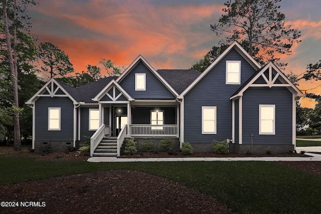 craftsman house featuring a yard and covered porch