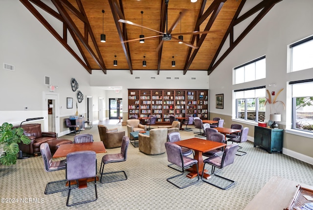 carpeted living room with wood ceiling, high vaulted ceiling, beamed ceiling, and ceiling fan