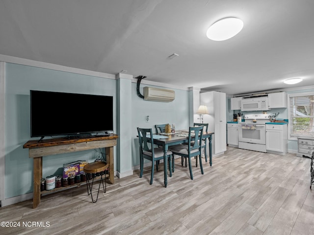 dining area with a wall mounted AC and light hardwood / wood-style flooring