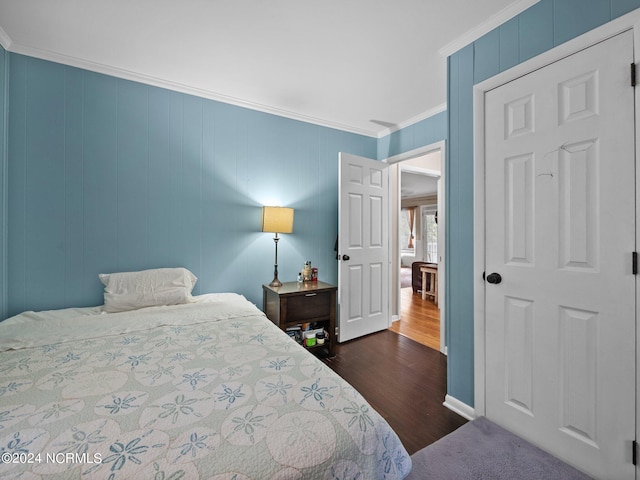 bedroom featuring ornamental molding and dark hardwood / wood-style flooring