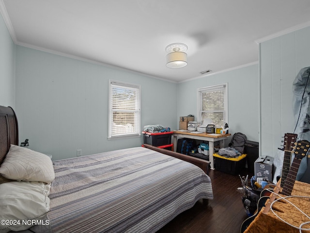 bedroom with ornamental molding and dark hardwood / wood-style flooring